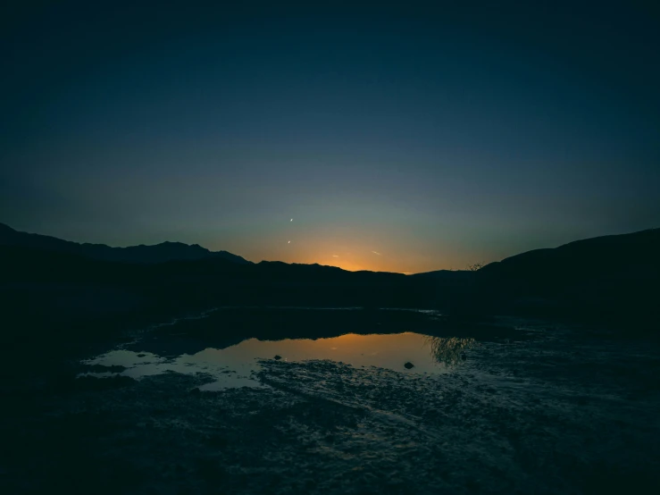 a water scene with mountains in the background