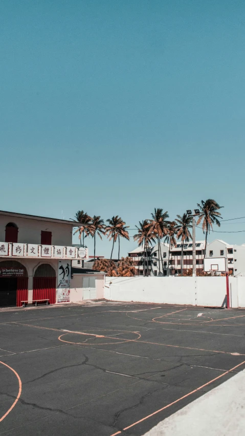 a parking lot on the side of a white building