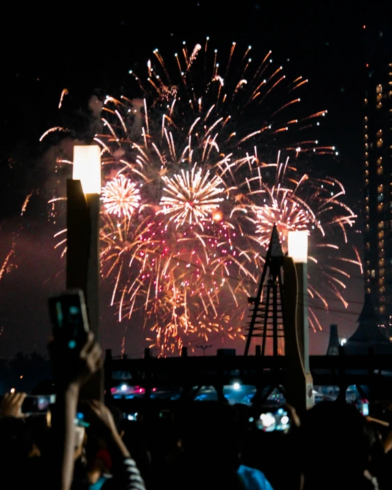 fireworks are being displayed during an event with people around it