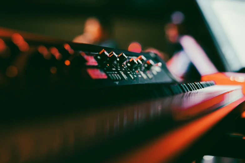 there is a musical keyboard sitting on the table