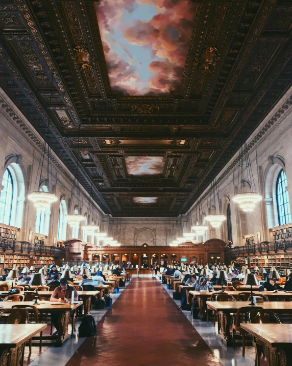 a large liry with people sitting at tables and working on computers