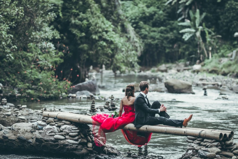 the couple is on a bridge crossing the river