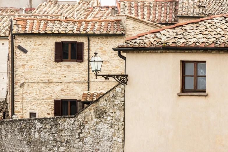 old stone building with a lamp post below