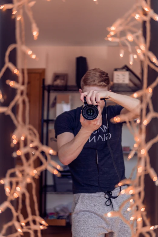 a young man takes a selfie through a mirror