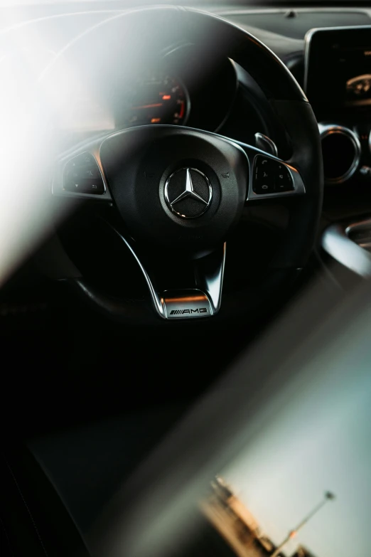 a dashboard of a mercedes vehicle with many steering wheel controls