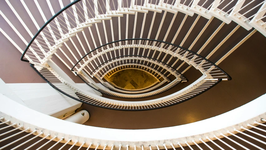 looking up at the spiral staircase in a house