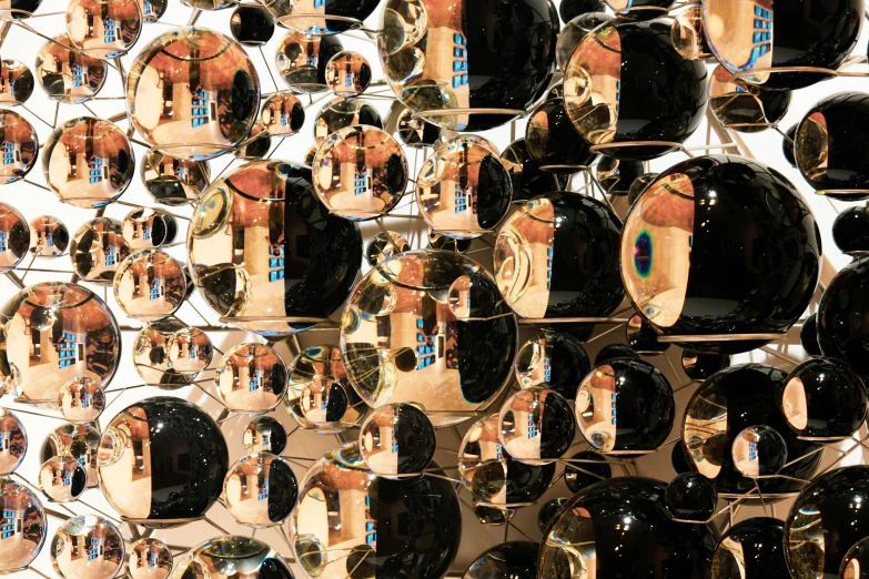 large mirrors in different sizes and shapes displayed on a wall