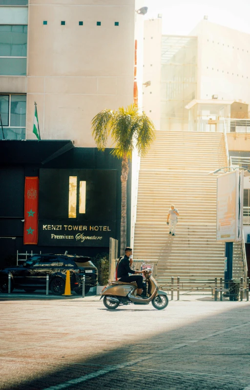 a motor cycle parked on the sidewalk in front of a el