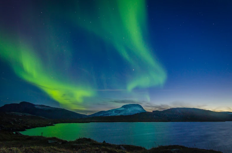 an image of the aurora lights over the mountains