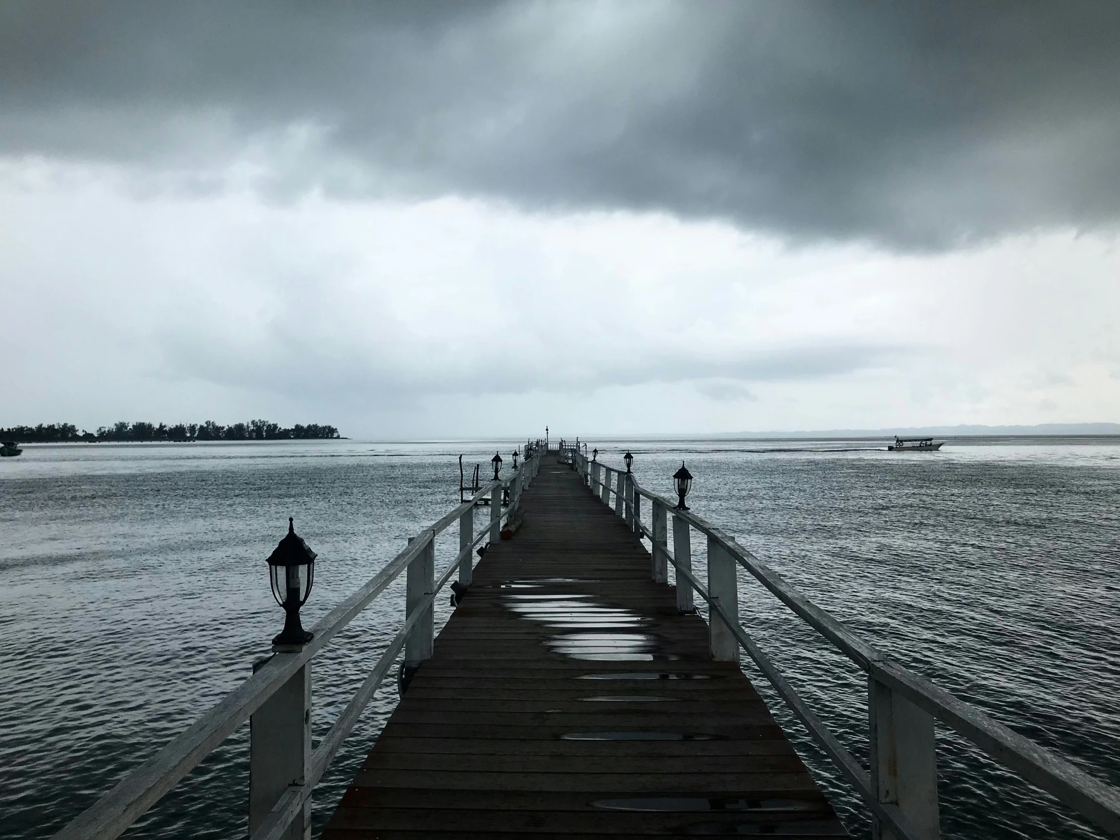 the pier has people crossing over the water