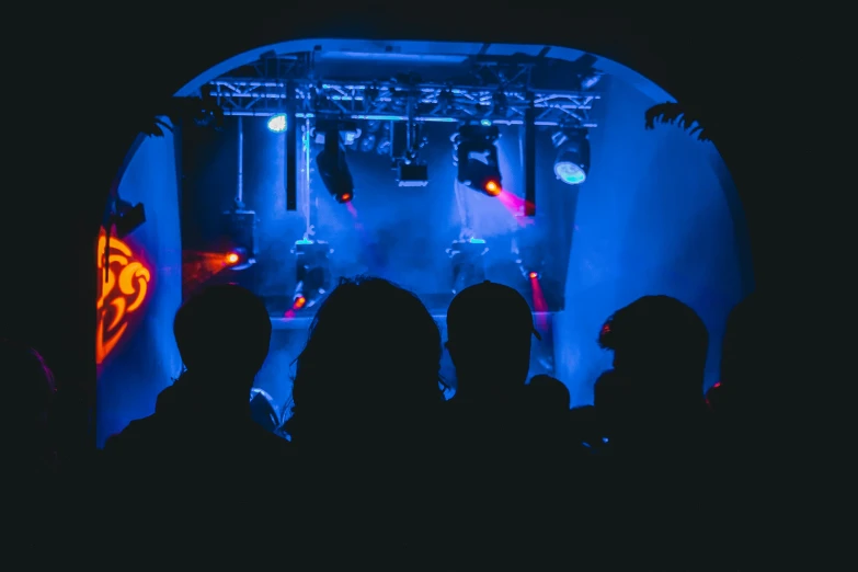 a group of people standing in front of a stage