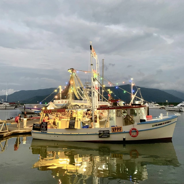 a boat sits docked with another boat nearby