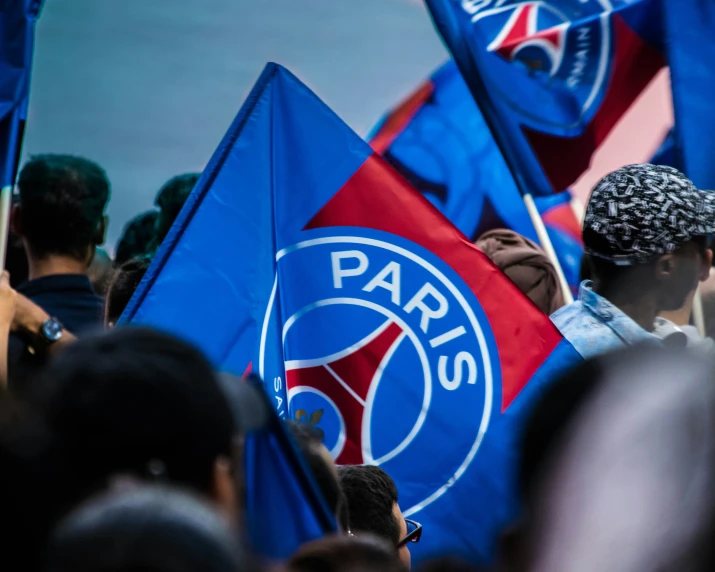 a group of people holding flags while standing next to each other