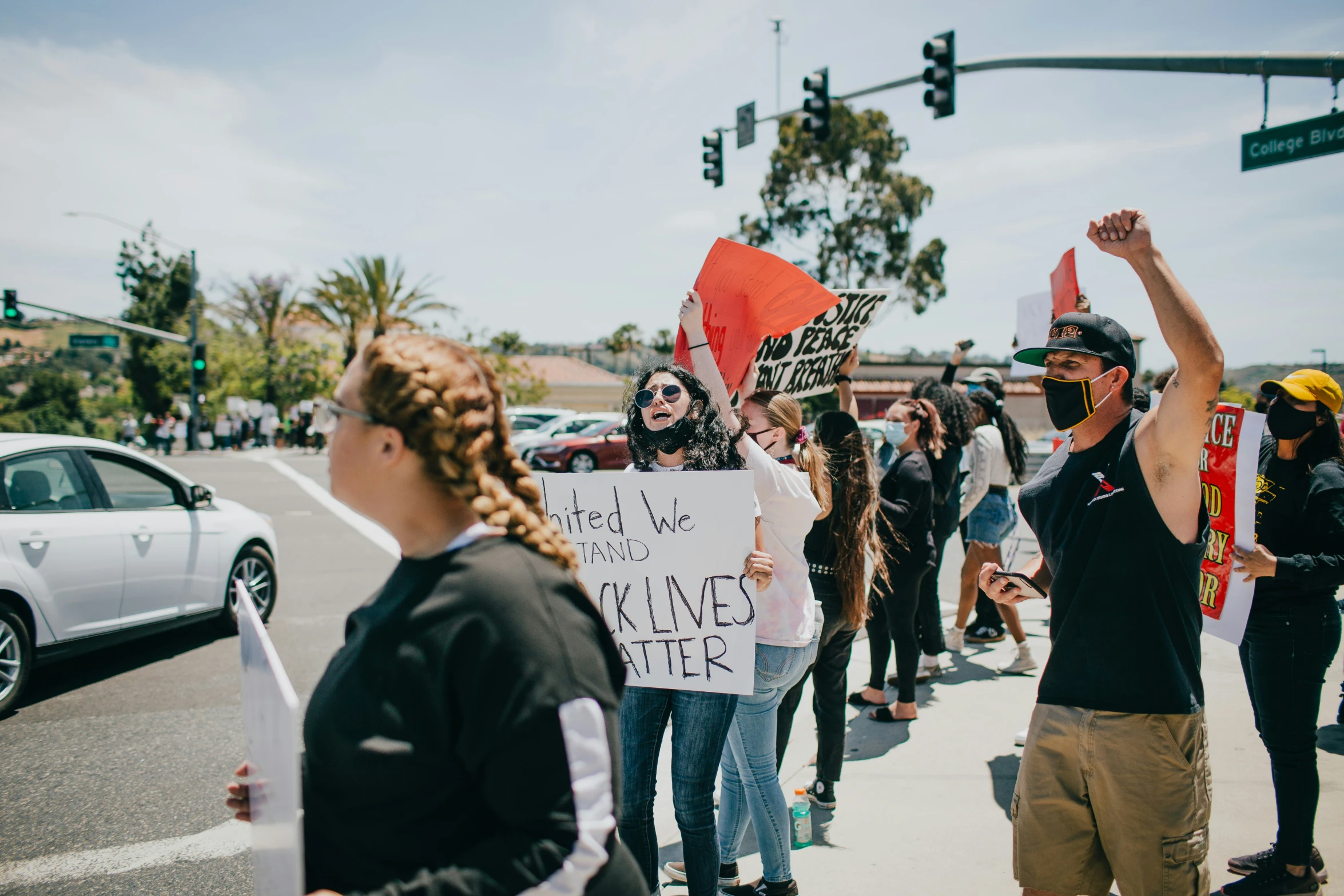 a group of protesters marching down the street, protesting against taxes