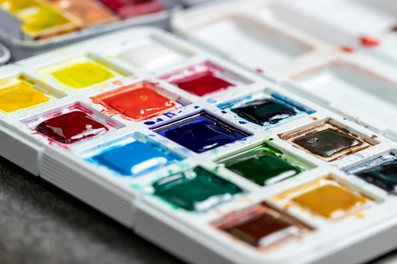 a palette with different colors of acrylic paints