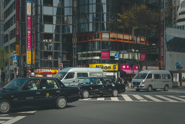 taxi cabs and cars on busy city street