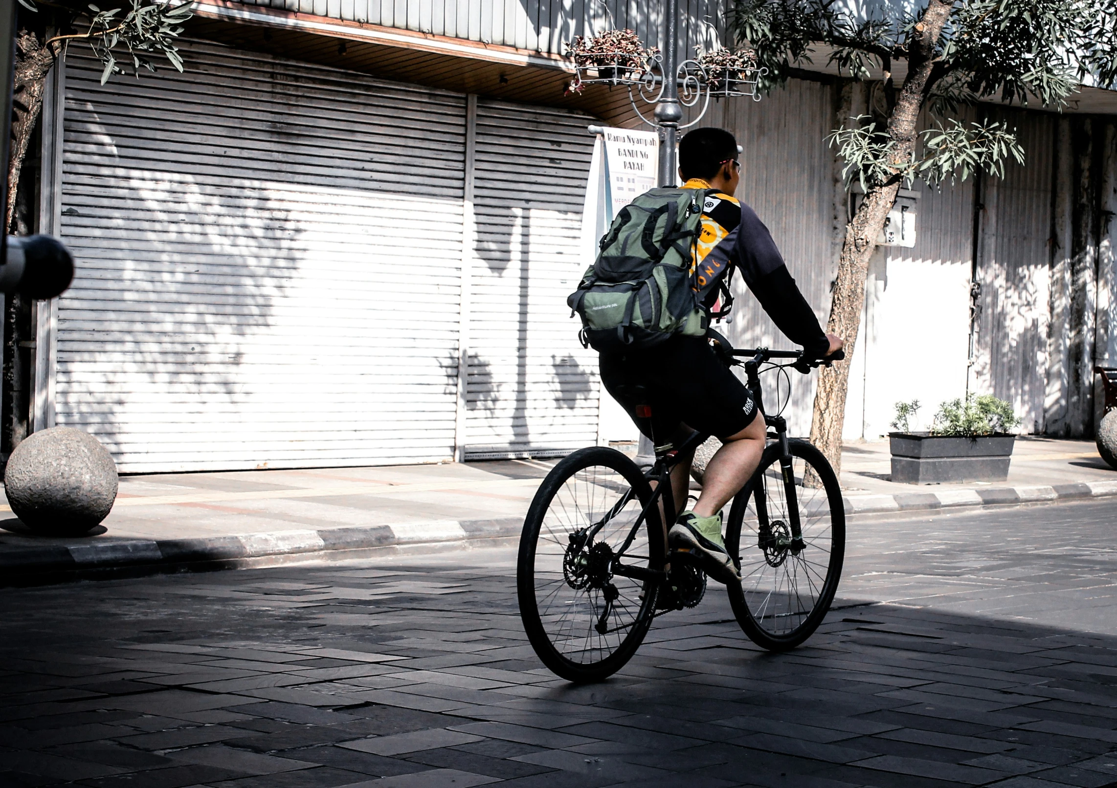 a man is riding a bike down the sidewalk