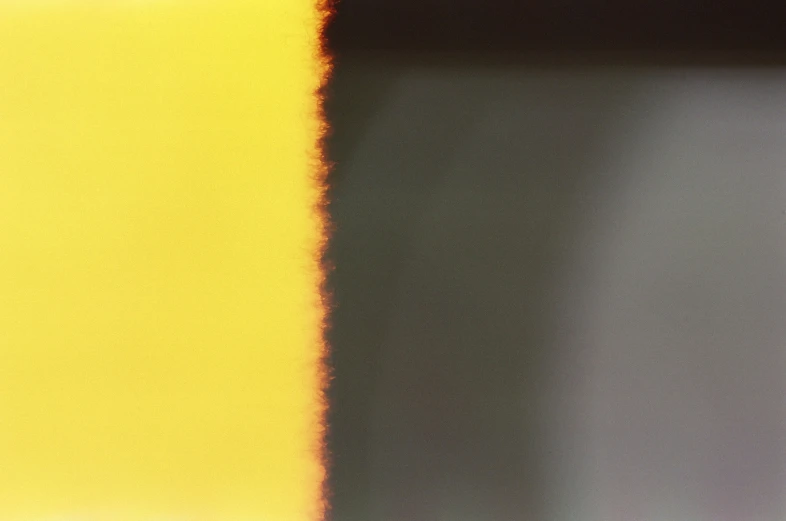 the blurry background of a bright yellow wall