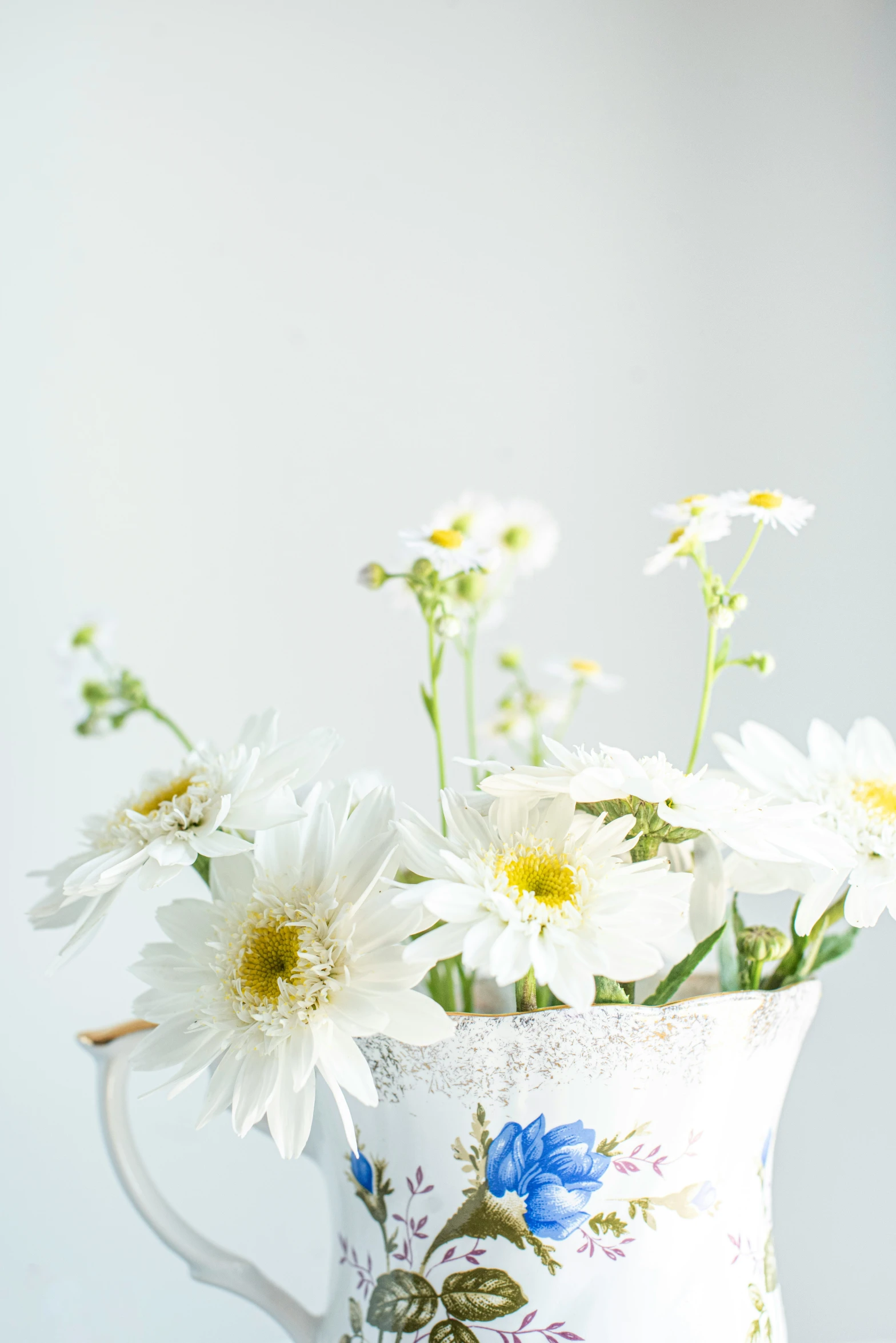 a bunch of white flowers in a pitcher