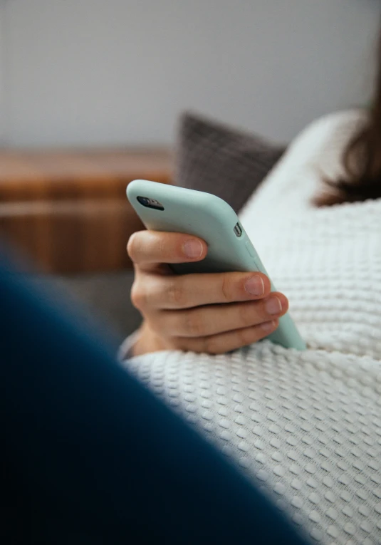 a close up of a person texting on a cell phone