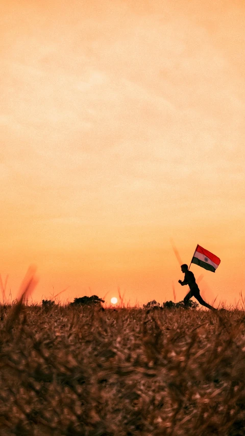 a man is holding a small kite while running