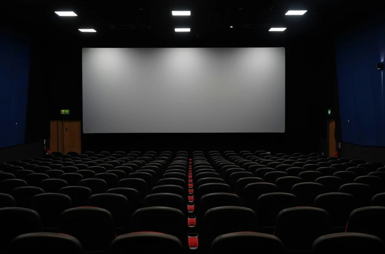 a large screen in an empty theatre, with seats facing it