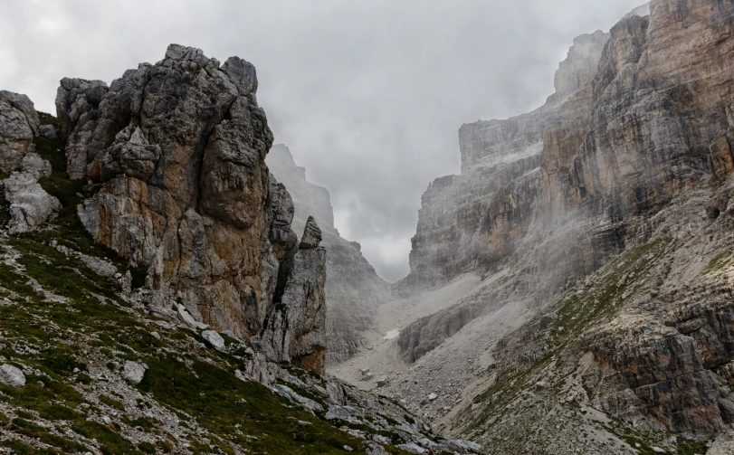 the rocky mountain slopes are bordered with a large rock formation