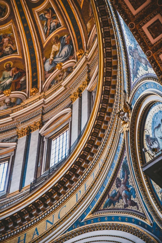 a very large church with murals on the ceiling