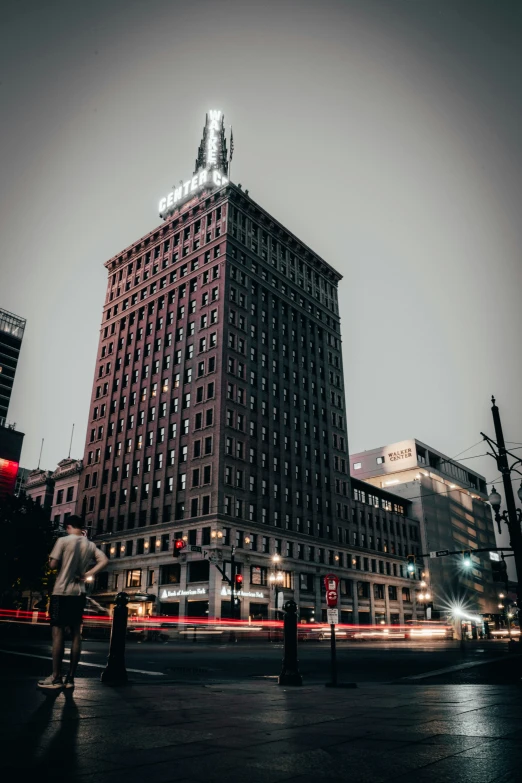 a red building with people walking and a traffic signal