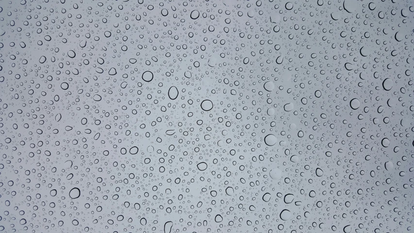 the back of an umbrella with lots of raindrops