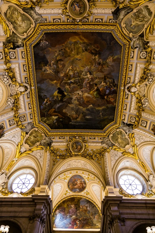 there is an intricate painting above the ceiling of this building