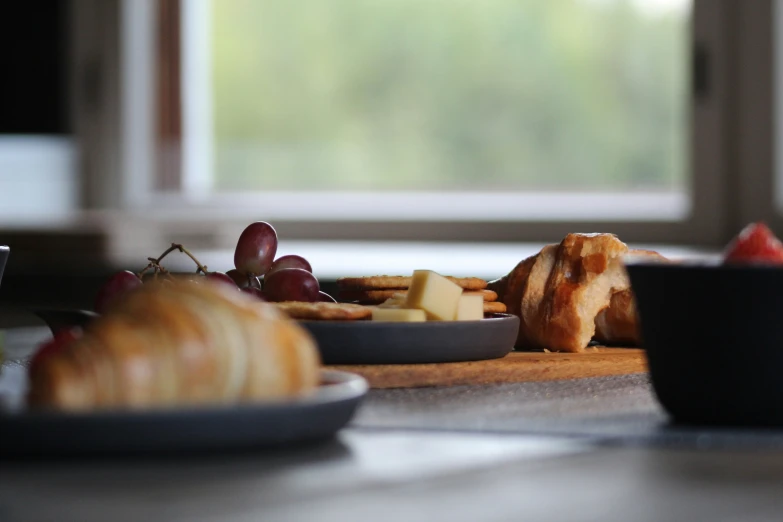 a table topped with plates of food and glasses of wine