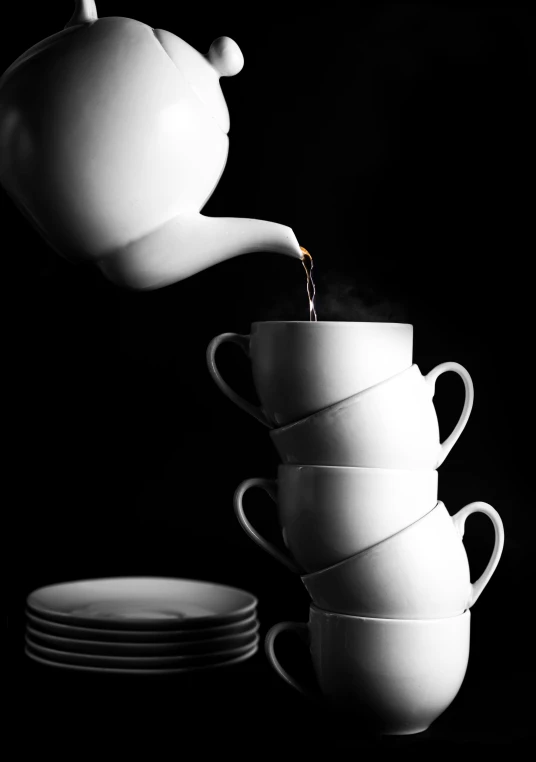 an artistic po with coffee being poured into white cups