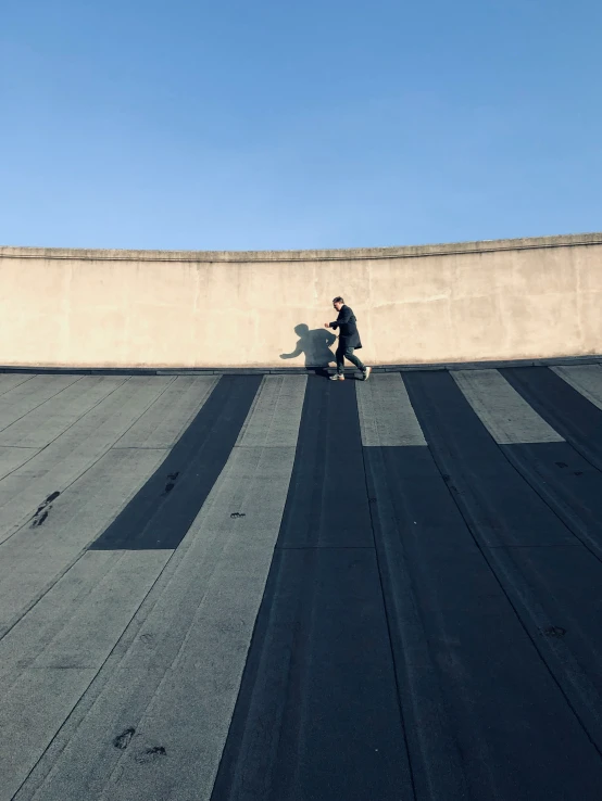 a person is walking on the edge of a roof