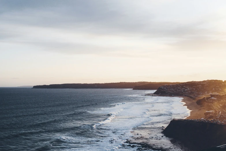 the coast and water are on one side and light shining up on it