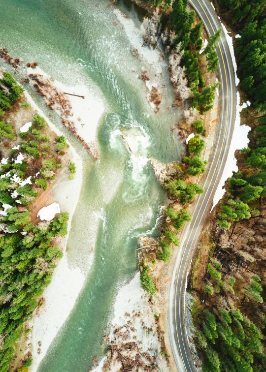 an aerial view of a river and trees