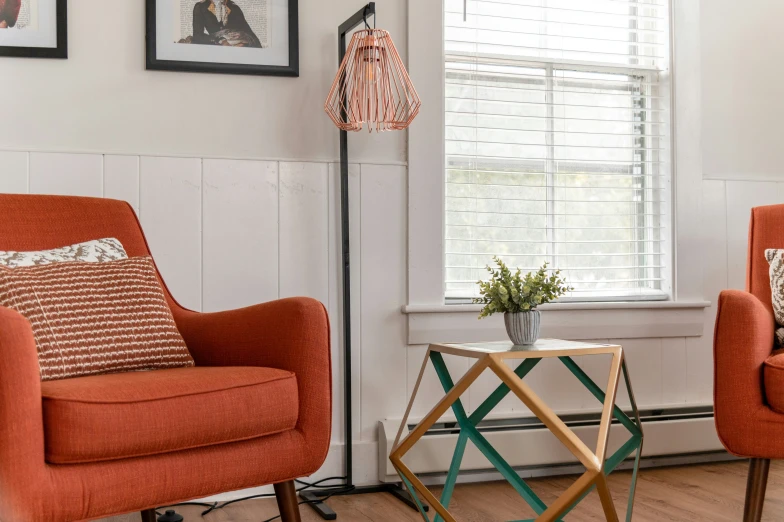 two chairs sit near one another and a table