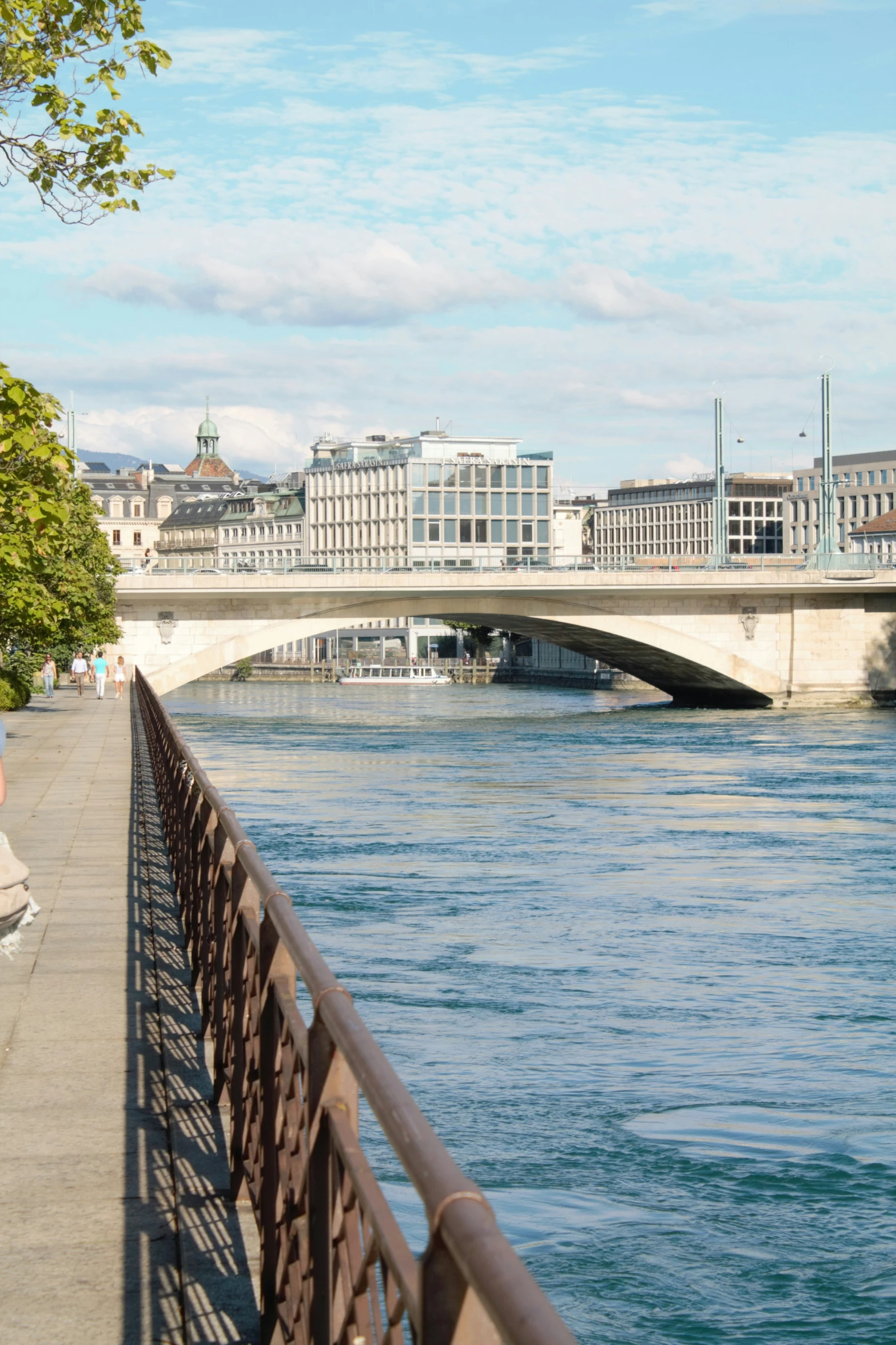 a bridge in a city over water near buildings