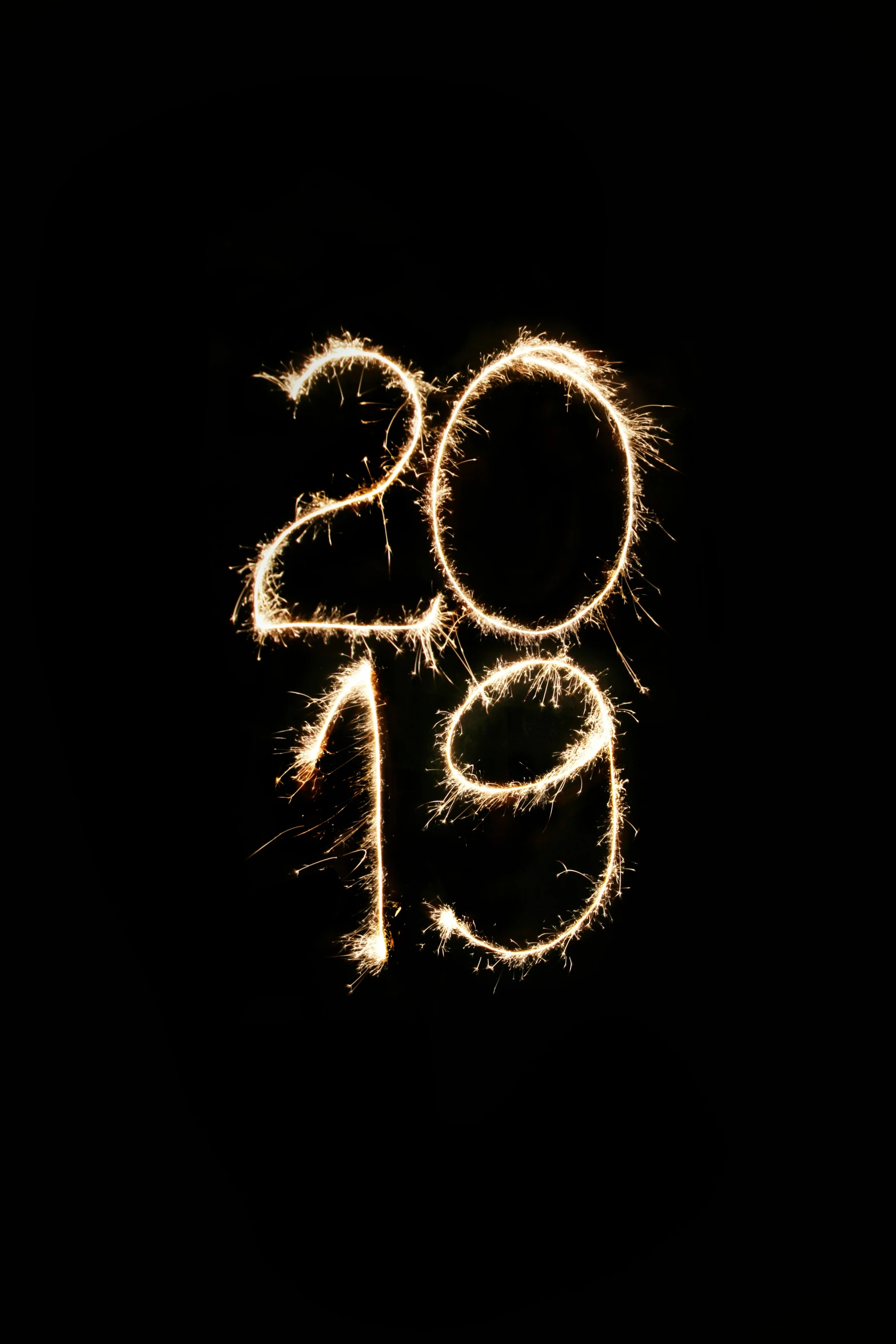 some orange and white sparklers are on a black background