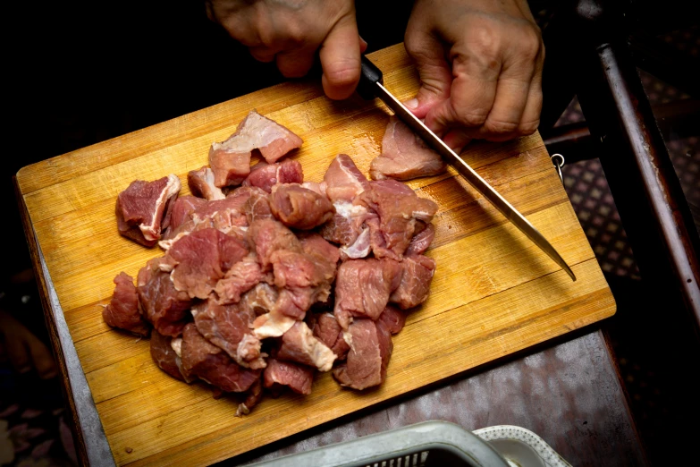 the man is chopping up food on a  board