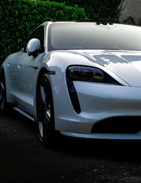 a white sports car is parked on the side of the road