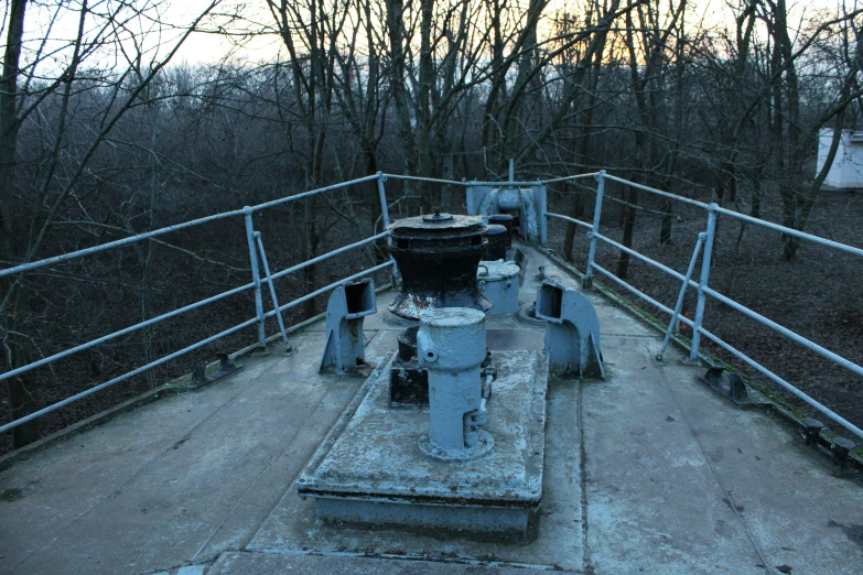 a gated bridge with machinery on top of it