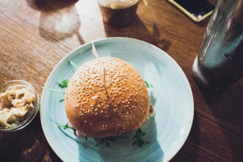 a close up of a sandwich on a plate with a beverage nearby