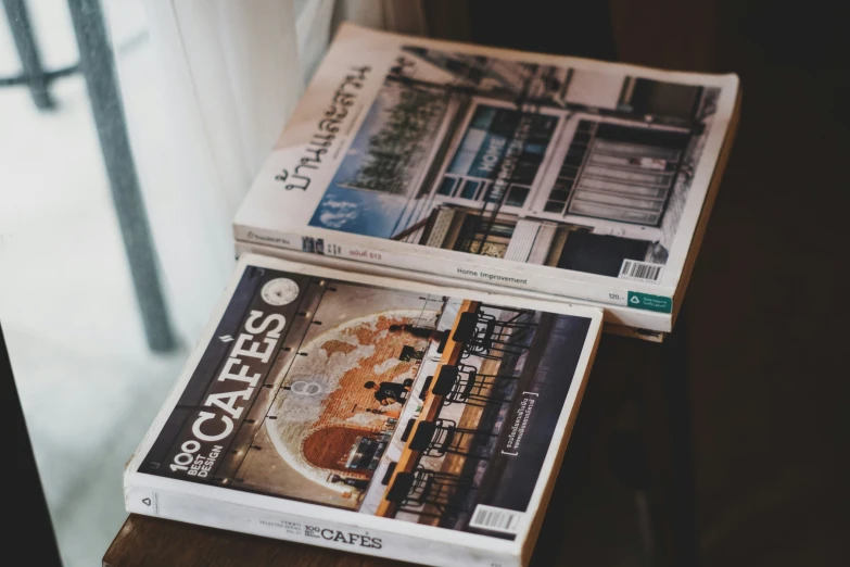 a stack of newspapers sitting on top of a table