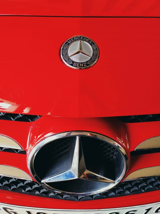 close up image of a car grille and chrome emblem