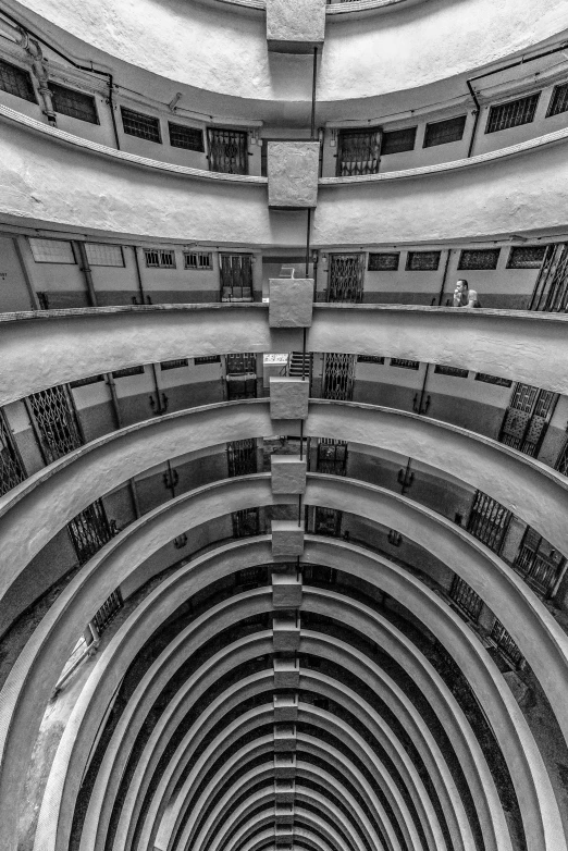 several people on skateboards ride down an empty hallway