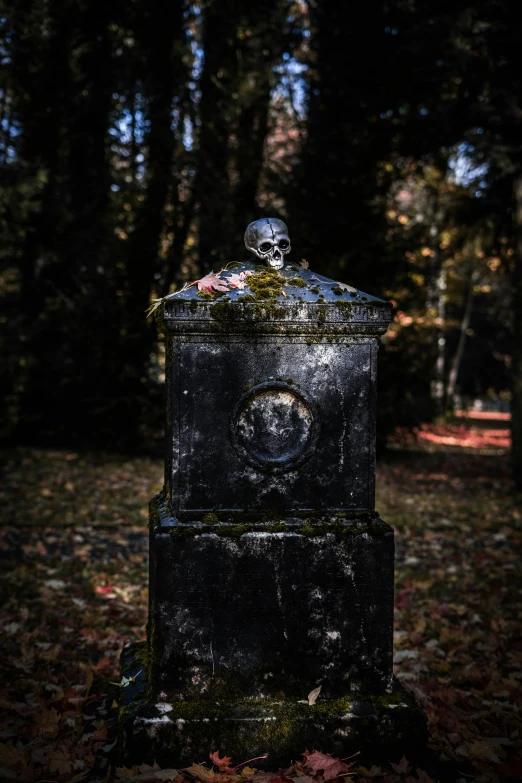 a stone monument sits in the middle of a park