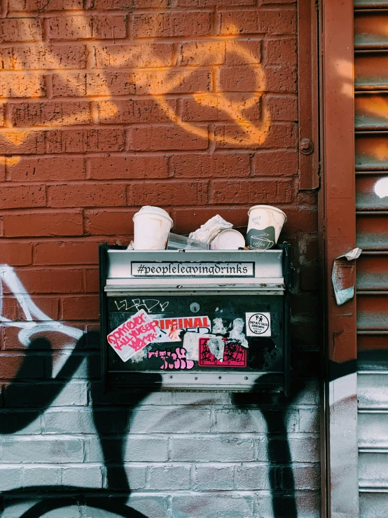 graffiti sprays on the brick wall above a food stand