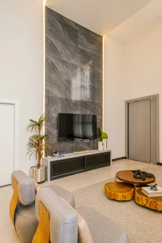 a large living room with wood furniture and tv on a wall