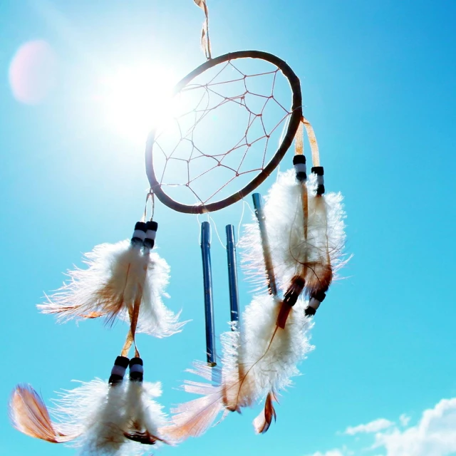 the sun shining through an native style dream catcher